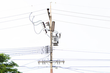 Energy and technology and transformers.  Electrical post by road with power line cables lamp for lighting. Phone lines against, internet cable 3G,4G,5G,  bright sunlight blue sky cloudy providing.