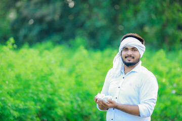 Indian happy farmer in Cotton fild, farmer holding cotton in hand