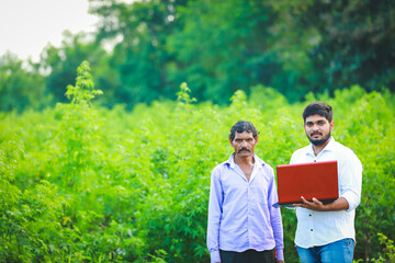 agronomist with farmer at cotton field