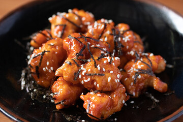 Fried chicken with Korean spicy sauce topped with seaweed