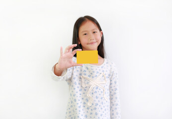 Asian little girl child showing blank yellow card on white background. Focus at card in his hand.