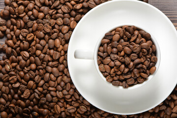 White coffee mug filled with coffee beans