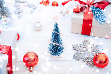 White wood background xmas decoration. Winter wooden holiday backdrop. Christmas board with old rustic wall, white frozen snow, golden balls and gift box. New year with copy space.