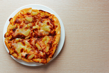 Close up of Pizza with pineapple,  mozzarella cheese, ham, bacon, pizza sauce. Sliced Hawaiian pizza texture, 