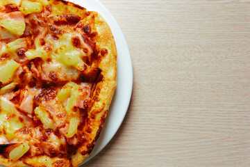 Close up of Pizza with pineapple,  mozzarella cheese, ham, bacon, pizza sauce. Sliced Hawaiian pizza texture, 