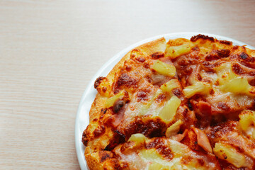Close up of Pizza with pineapple,  mozzarella cheese, ham, bacon, pizza sauce. Sliced Hawaiian pizza texture, 