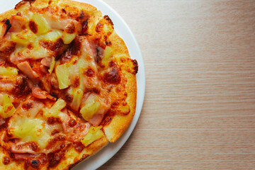Close up of Pizza with pineapple,  mozzarella cheese, ham, bacon, pizza sauce. Sliced Hawaiian pizza texture, 