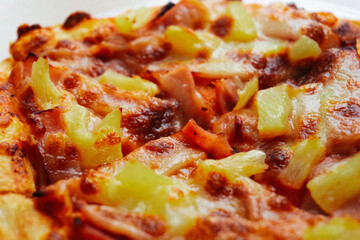 Close up of Pizza with pineapple,  mozzarella cheese, ham, bacon, pizza sauce. Sliced Hawaiian pizza texture, 