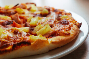 Close up of Pizza with pineapple,  mozzarella cheese, ham, bacon, pizza sauce. Sliced Hawaiian pizza texture, 