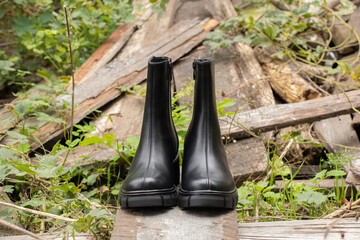 womens high black boots with thick soles stand on logs, womens shoes winter, footwear