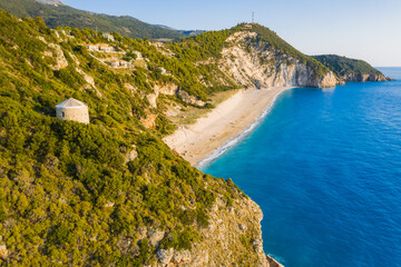 Obraz premium Aerial view of Milos beach near the Agios Nikitas village on Lefkada Ionian island, Greece. Evening sunset golden light