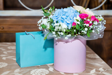 a bouquet of many delicate flowers in a gift box. Close-up. Background Holiday gift.
