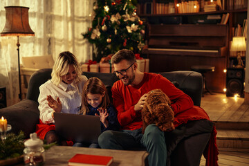 Family celebrating with siblings Christmas via video call