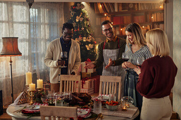 Friends having lunch together at a table during Christmas time