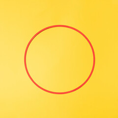 red circle with copyspace against yellow illuminating background. minimalism