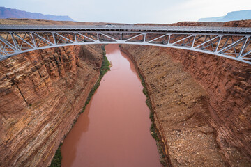 Navajo Bridge, Marble Canyon,  Glen Canyon National Recreation Area, Arizona. Red colored water of Colorado river