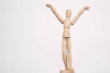 wooden man mannequin posing object light background