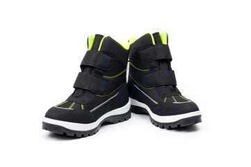 Demi-season teenage boots in dark gray with Velcro fasteners shot against a white background.