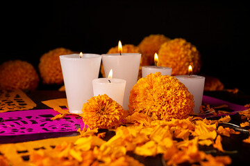 Candles with Cempasuchil orange flowers or Marigold. (Tagetes erecta) and Papel Picado. Decoration...