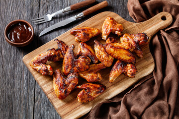 crispy fried chicken wings on a wooden board