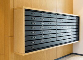 Mailboxes for letters and correspondence. Modern black mailboxes with numbers in the lobby of a residential or office building