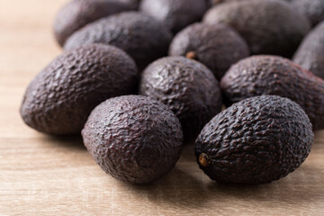 Ripe hass avocado fruit on wooden background, Healthy fruit