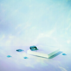 Abstract surreal scene - empty stage with white square podium on holographic pastel blue colored...