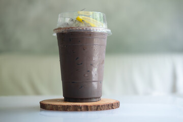 A glass of iced chocolate and decoration with slice lemon
