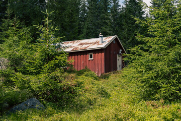 a red cabin in the hills