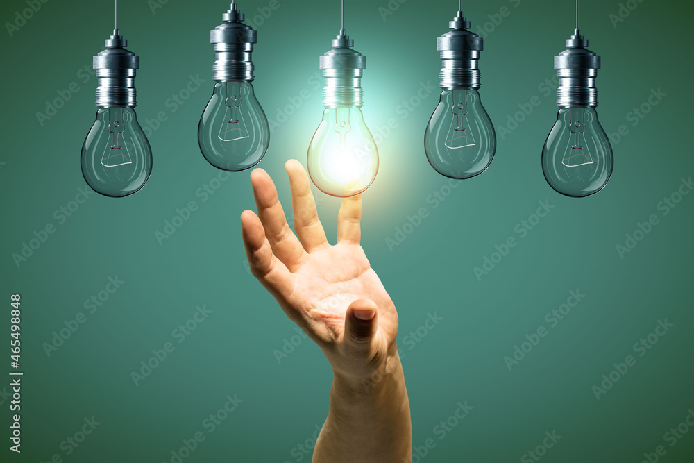Aufkleber close up of businessman hand holding abstract glowing row of light bulbs on blue background. idea, s