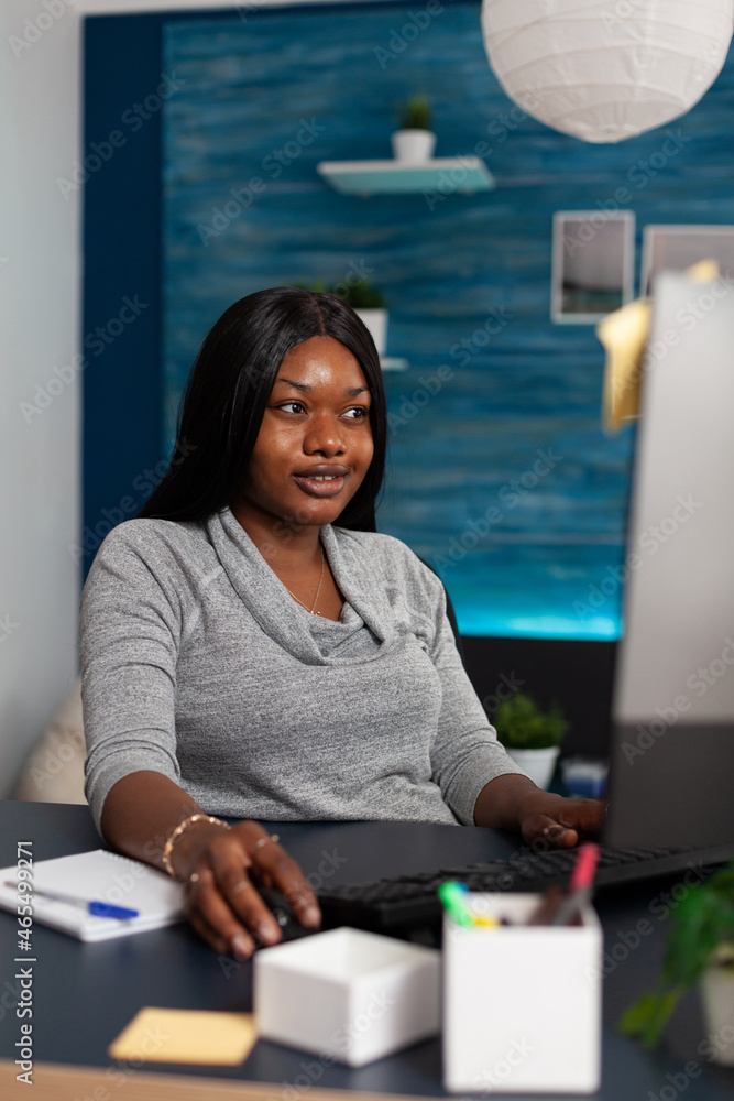Poster smiling adult doing remote work with computer and keyboard. woman using monitor and internet connect