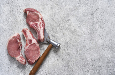 Fresh meat. Ribs and ax on a light background. Pork steak.