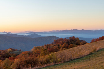 A sunrise over the mountains and forests