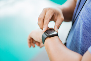 close up of a man's hand holding and setting a watch