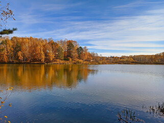 autumn lake during sunny day in siberia russia yellow trees