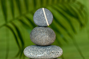 Balanced Pebble Stone Cairn Across Green