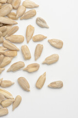 Pipas de girasol peladas crudas sobre fondo blanco