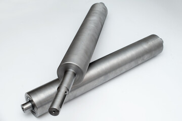 Steel metal pipe-shaft made on a lathe for the factory conveyor industry.