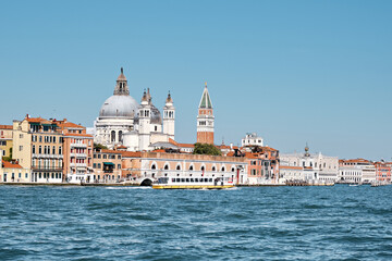Old buildings on Dorsodouro promenade, cupola of Santa Maria della Salute church, St Mark's...