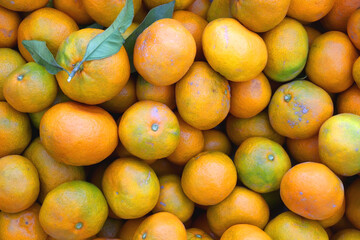 Wooden crate filled with fresh tangerines. Top view.