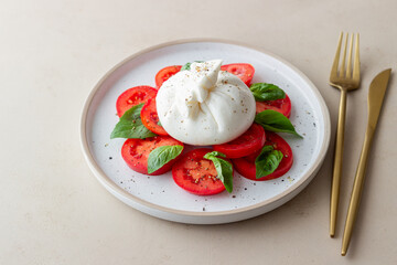 Italian burrata cheese with tomatoes and basil. Salad. Healthy eating. Vegetarian food.