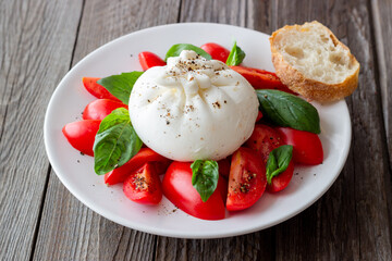 Italian burrata cheese with tomatoes and basil. Salad. Healthy eating. Vegetarian food.