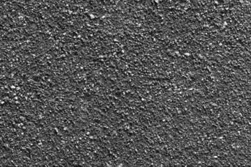 texture of gray with pebbles asphalt in sunlight