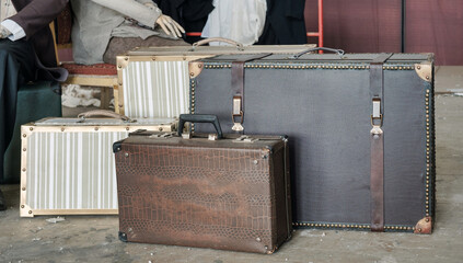 Group of old vintage leather brown suitcases on the dirty floor