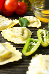 Concept of cooking ravioli on wooden background