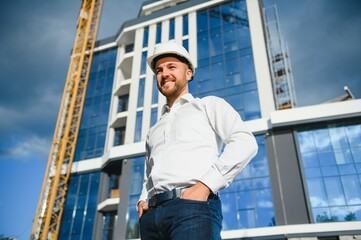 A construction worker control in the construction of roof structures on construction site and sunset background