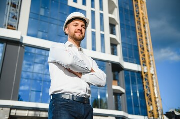 A construction worker control in the construction of roof structures on construction site and sunset background