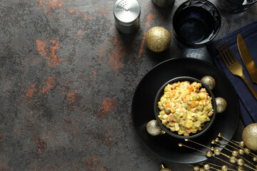 Christmas concept of tasty food with Olivier salad on dark background