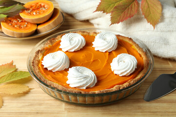 Concept of tasty food with pumpkin pie on wooden background