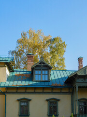 front of house with windows and a green roof